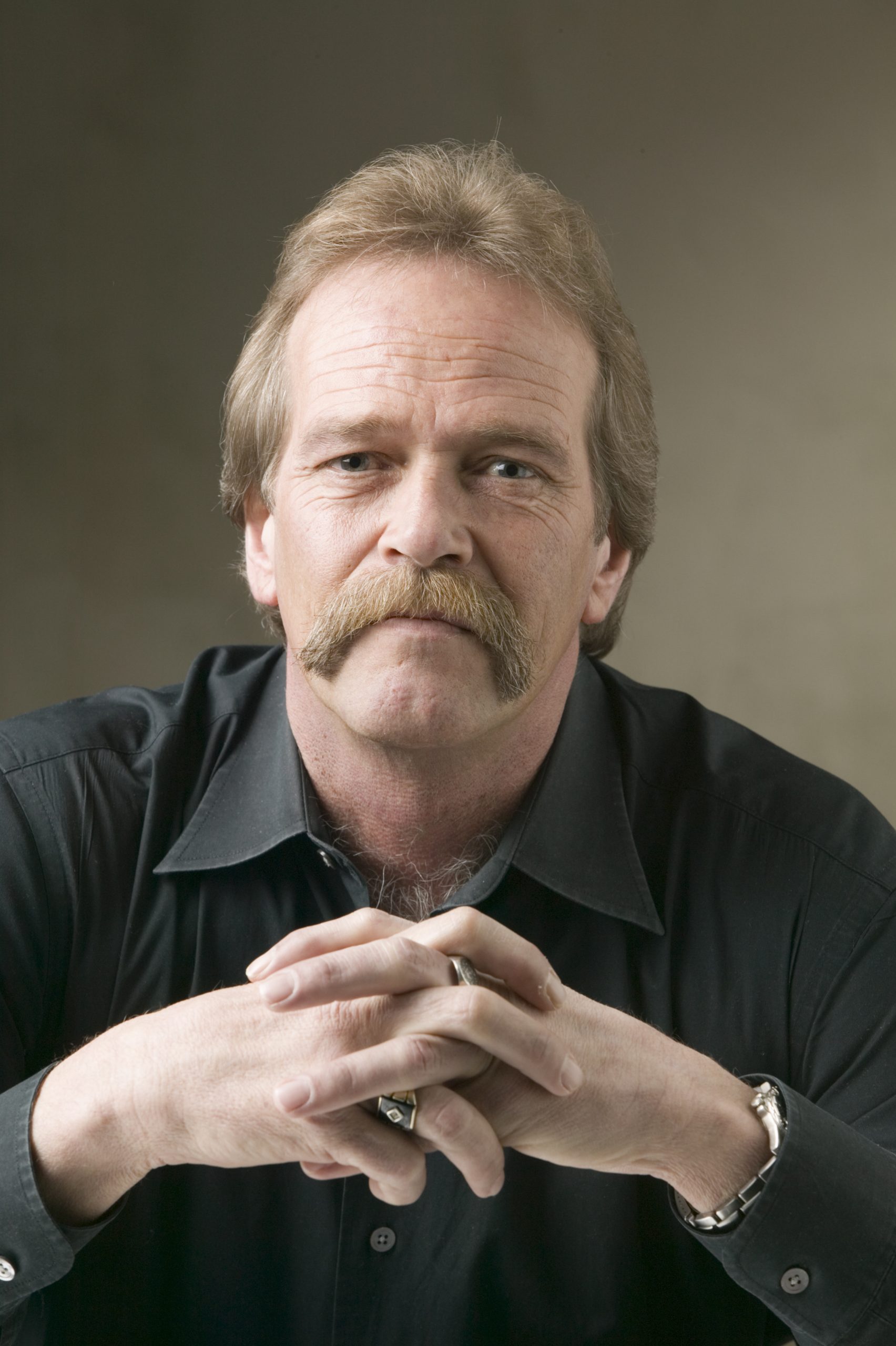 man with moustache posing in studio, portrait